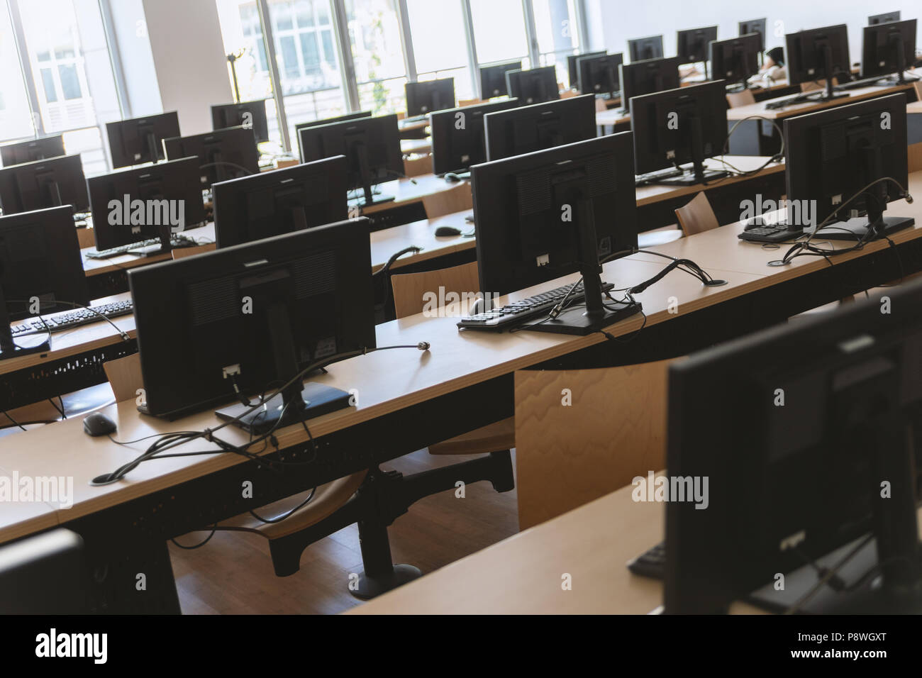 Angled view of classroom with many desktop computers. Stock Photo