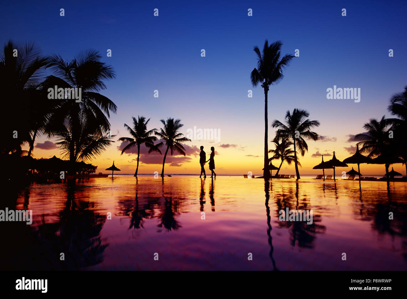 Silhouettes of young couple at scenic sunset on tropical beach Stock ...