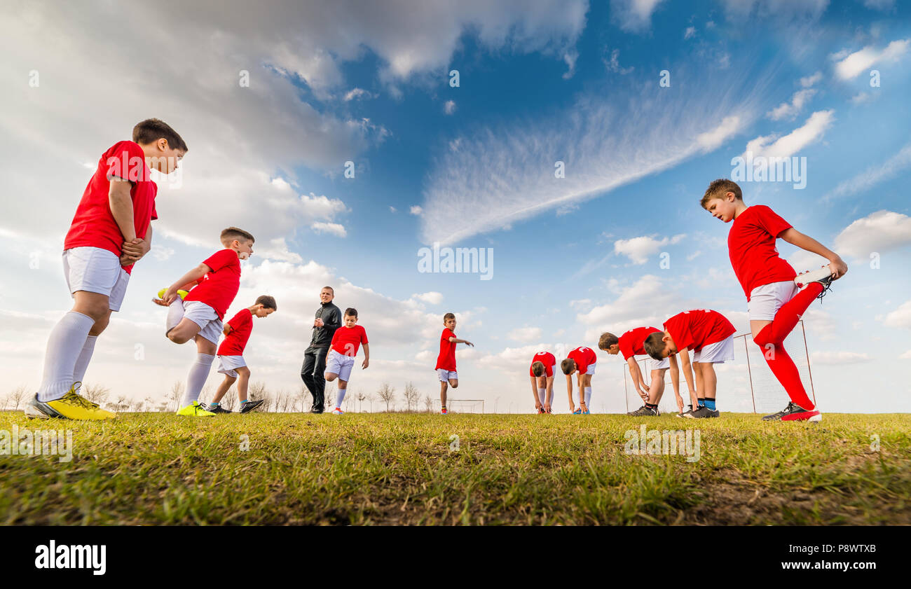 Kids soccer team exercise on soccer field Stock Photo Alamy