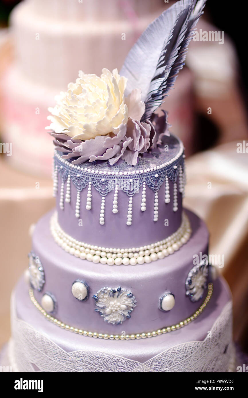 Purple Wedding Cake Decorated With Flowers And Pearls Stock Photo