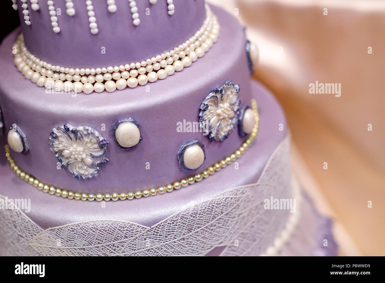 Purple Wedding Cake Decorated With Flowers And Pearls Stock Photo