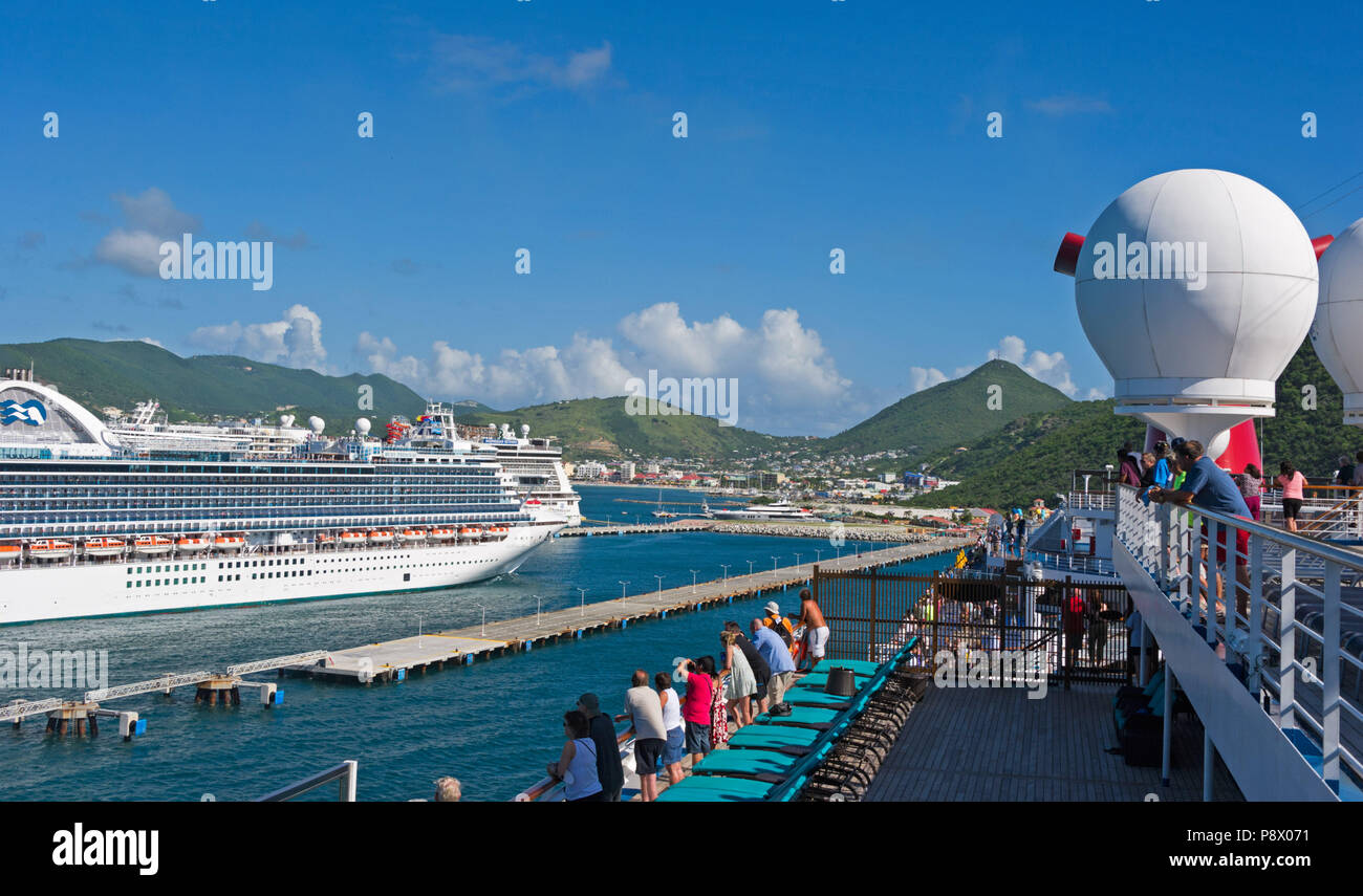 Passengers on Carnival Freedom Cruise ship watching Ruby Princess Cruise Ship arrive at San Juan Stock Photo