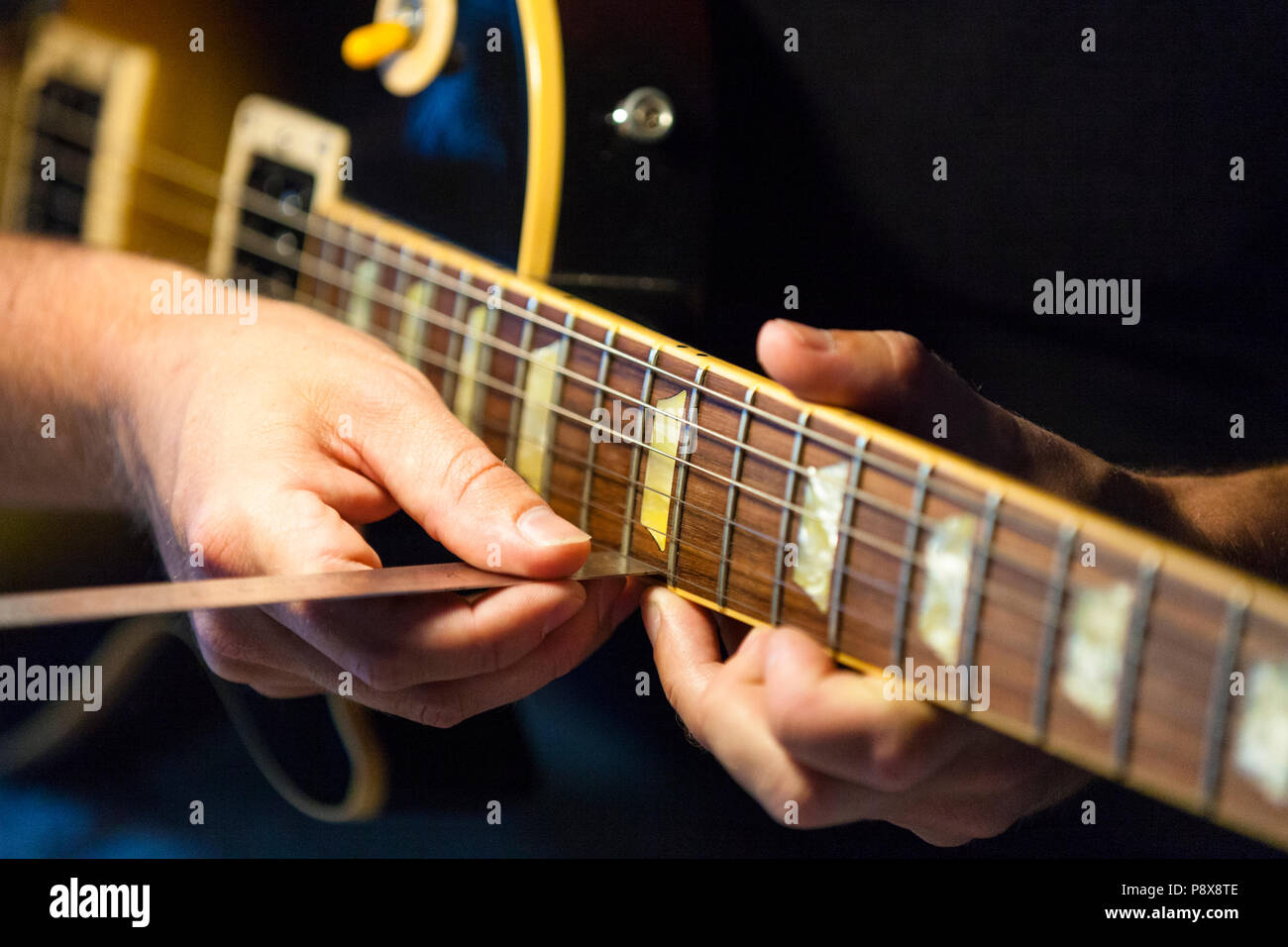 Measuring the string height or “action” which is part of a guitar setup