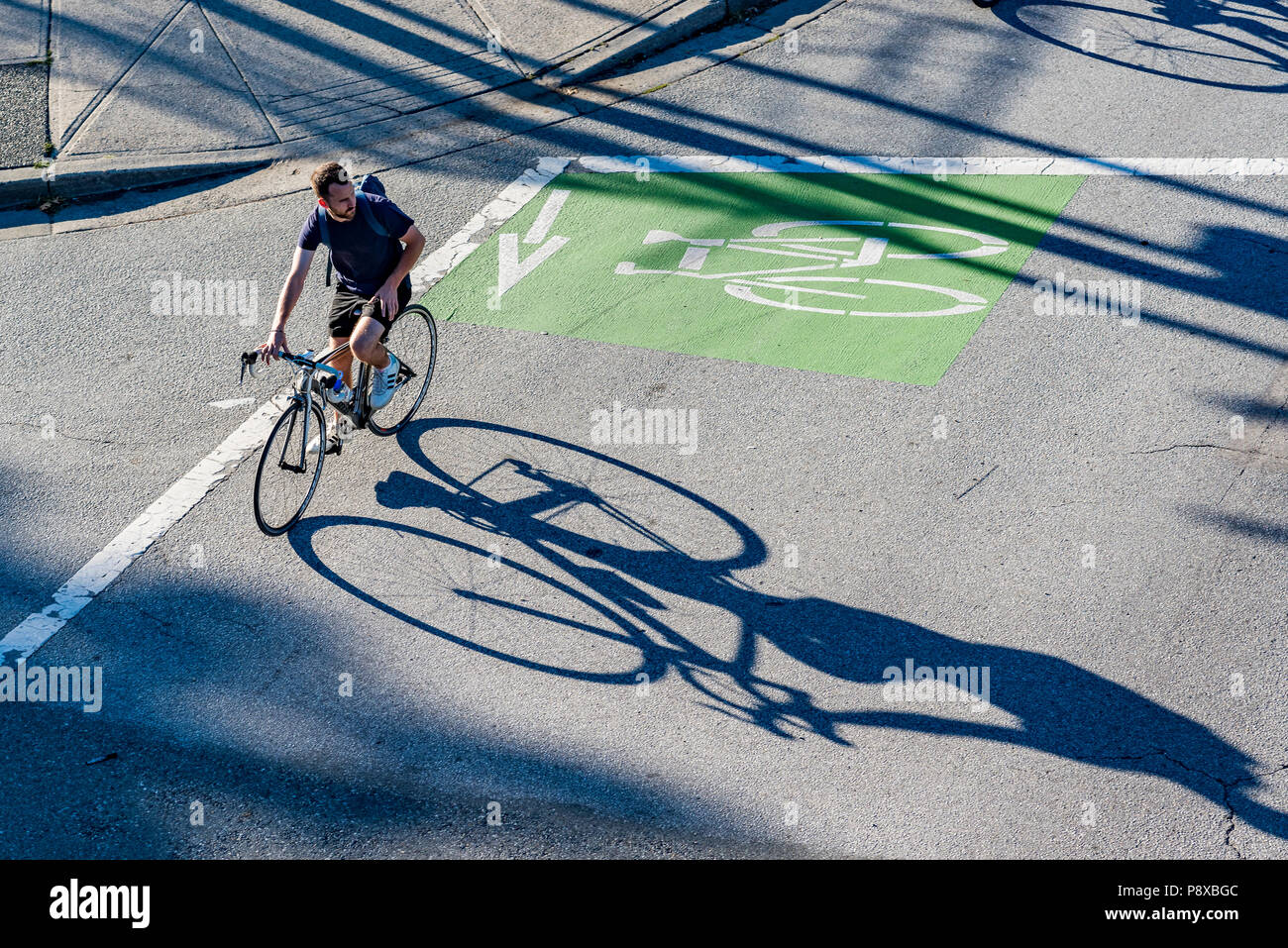 Cyclist using dedicated bike lane, Vancouver, British Columbia, Canada. Stock Photo