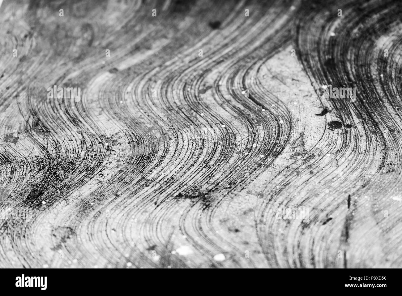 Concrete floor with curved patterns and stains in black and white Stock Photo