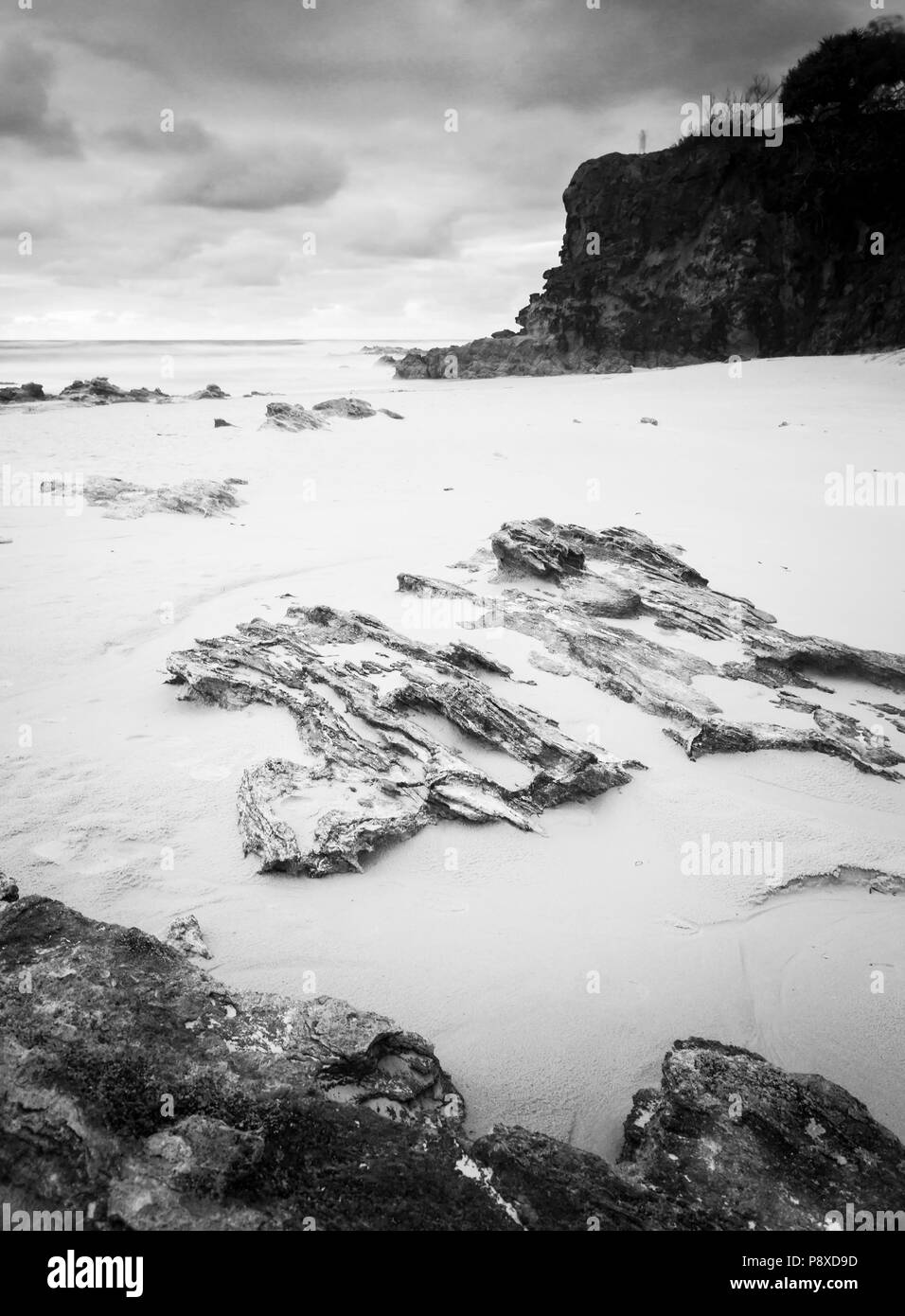 Deadmans Beach sunrise view towards Frenchmans Beach on Stradbroke Island, Queensland, Australia in black and white Stock Photo