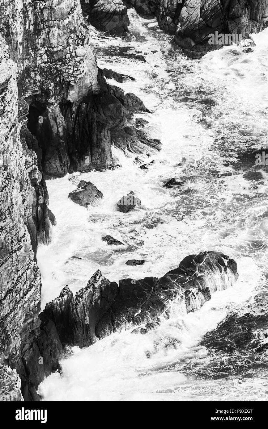 Ocean cliffs on the Cape of Good Hope, South Africa in black and white Stock Photo