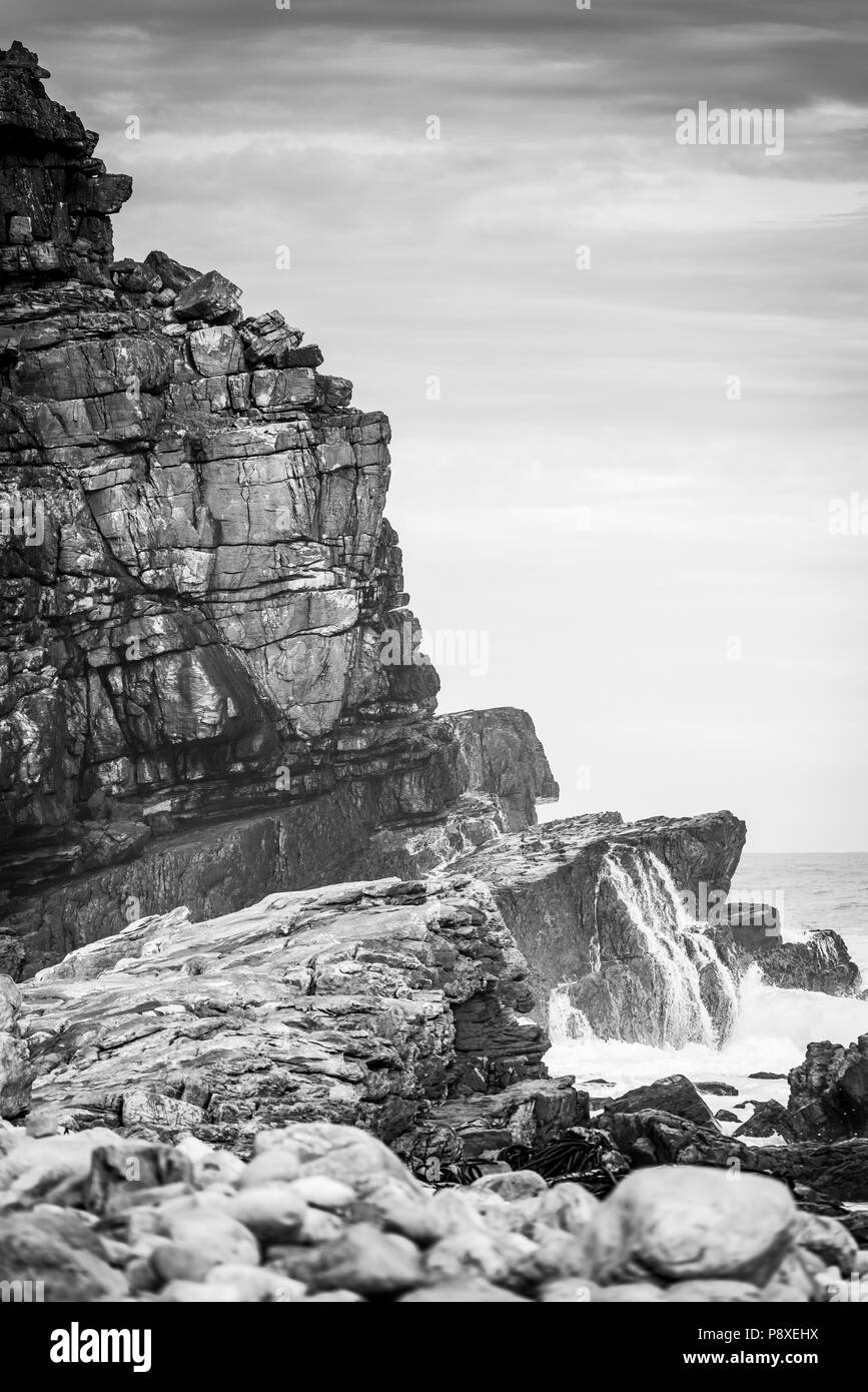 Ocean cliffs on the Cape of Good Hope, South Africa in black and white Stock Photo