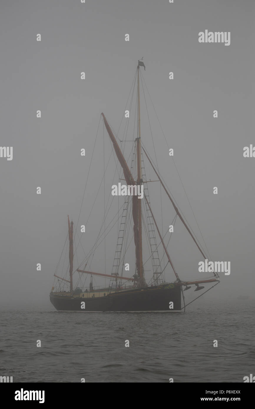 Sailing ship in fog on the Norfolk coast Stock Photo