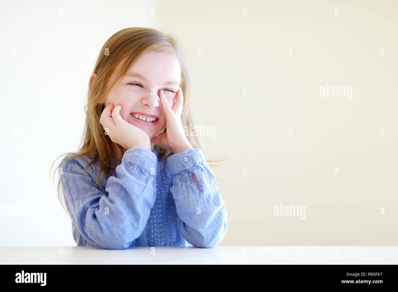 Portrait of a cute little happy girl at home Stock Photo - Alamy