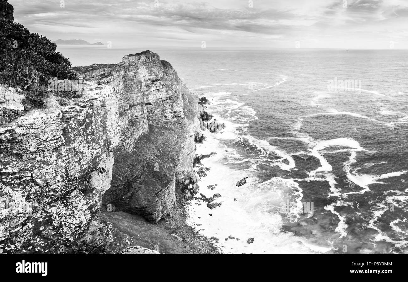 South African rocky ocean coastline along the Cape of Good Hope in black and white Stock Photo