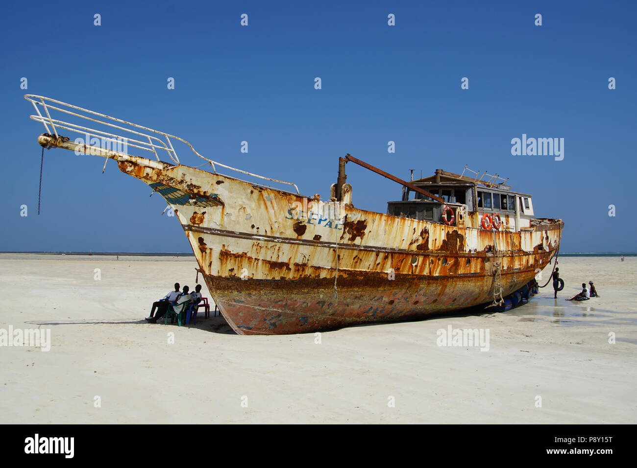 Boat beached on Bamburi Beach, near Mombasa in Kenya Stock Photo