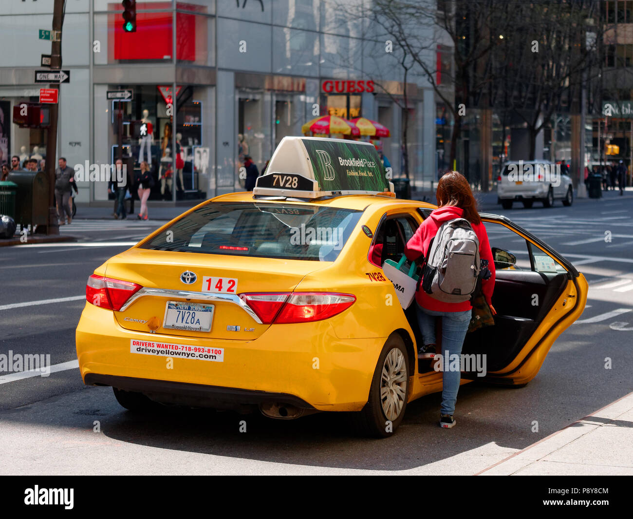 New York City, USA - May 2018: Woman taking taxi on fifth avenue in Manhattan Stock Photo