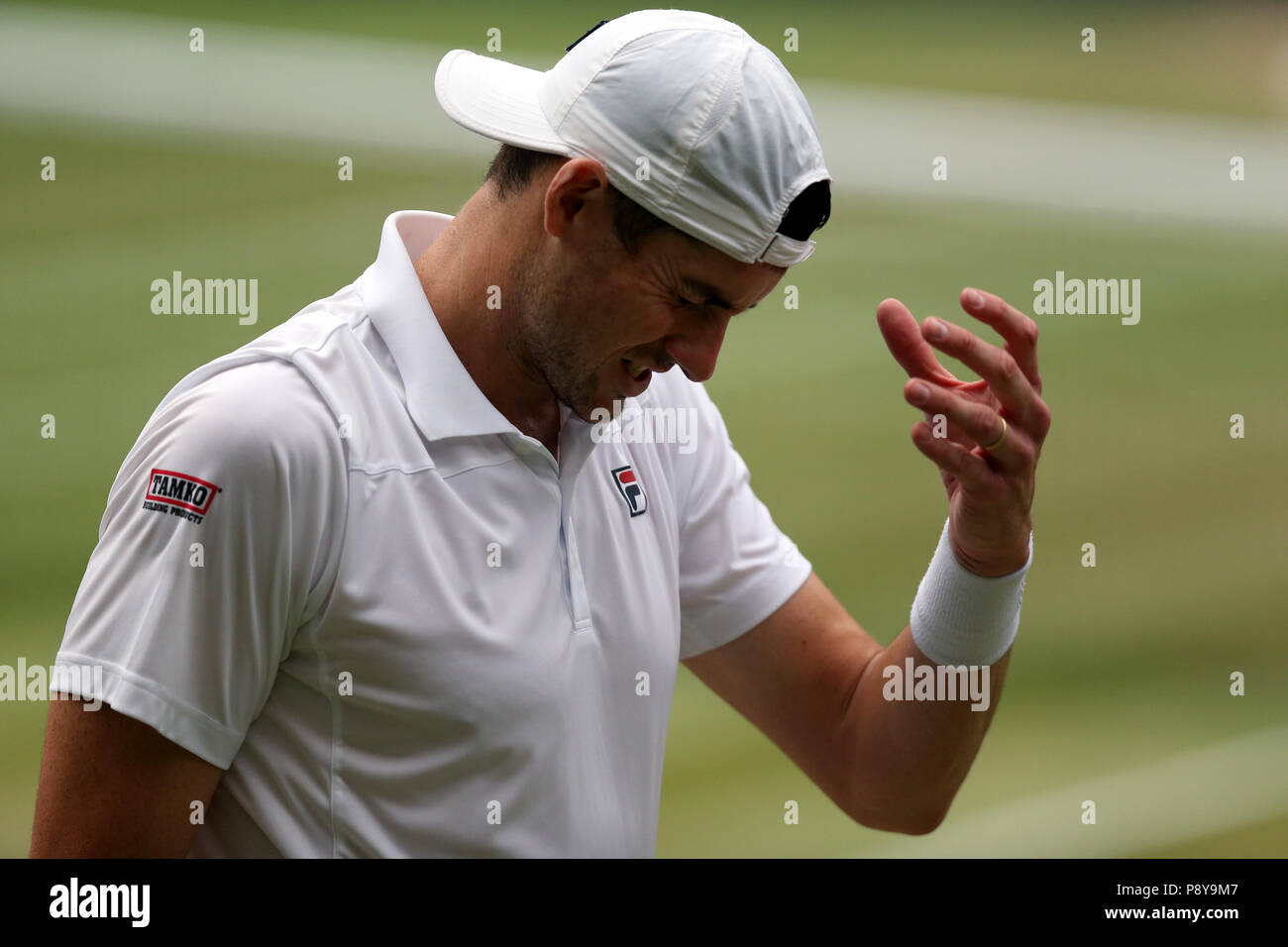John Isner reacts on day eleven of the Wimbledon Championships at the All England Lawn Tennis and Croquet Club, Wimbledon. Stock Photo