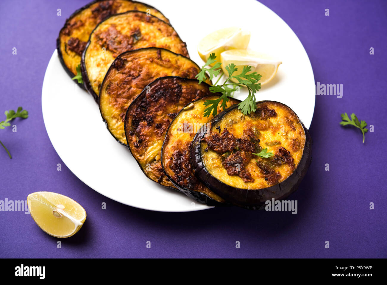 Pan fry crispy baigan / eggplant / brinjal recipe from India. selective