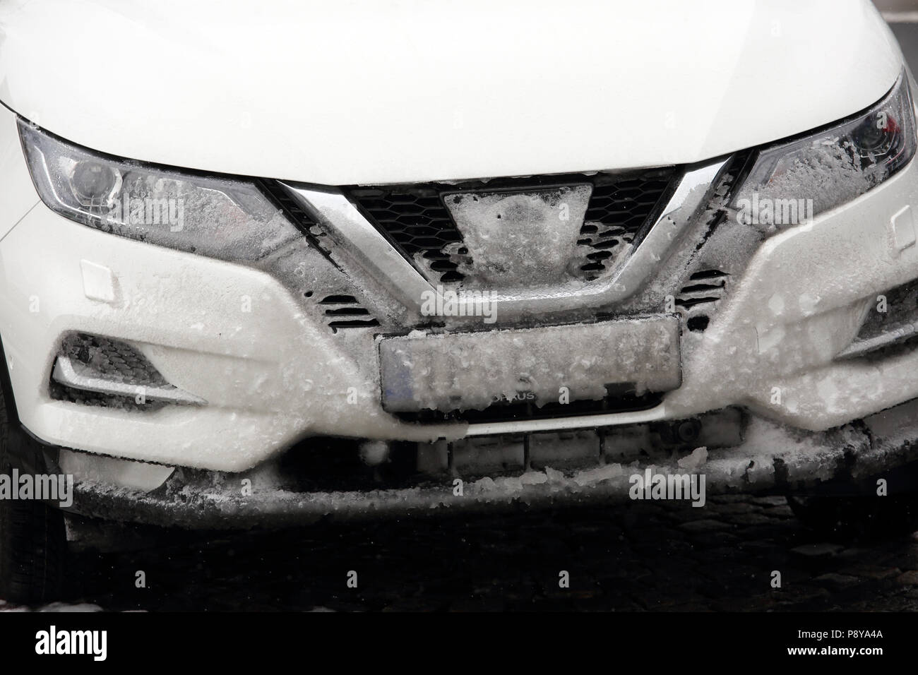 Munich, Germany, license plate of a car is covered in snow Stock Photo