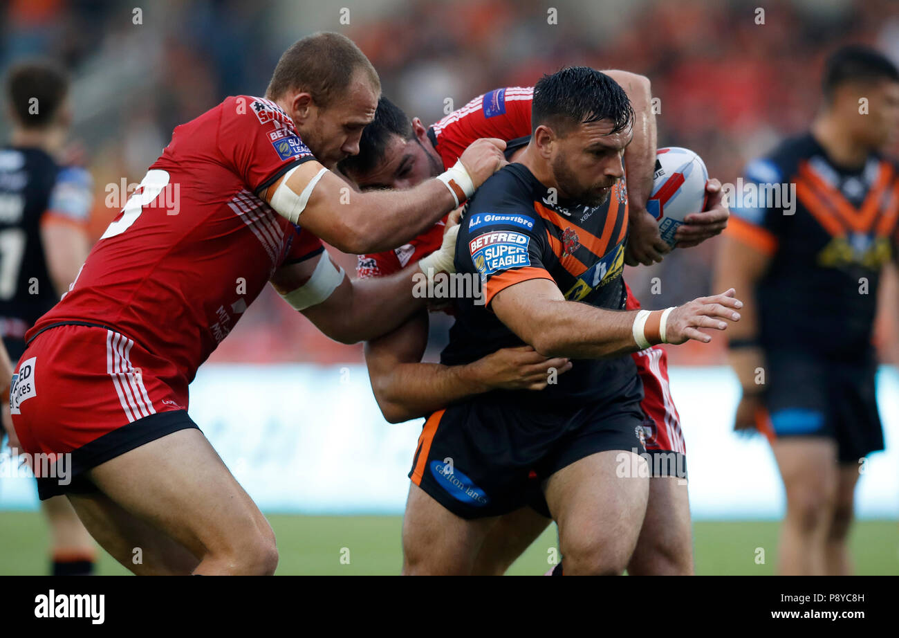 Castleford Tiger's Matt Cook is tackled by Salford Red Devils' Lee Mossop and Mark Flanagan during the Betfred Super League match at the AJ Bell Stadium, Salford. Stock Photo