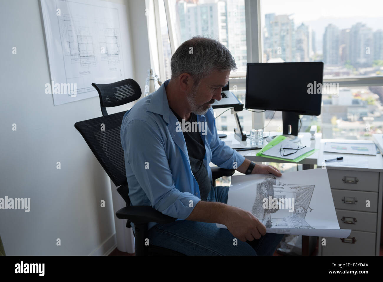 Man looking at architectural chart Stock Photo