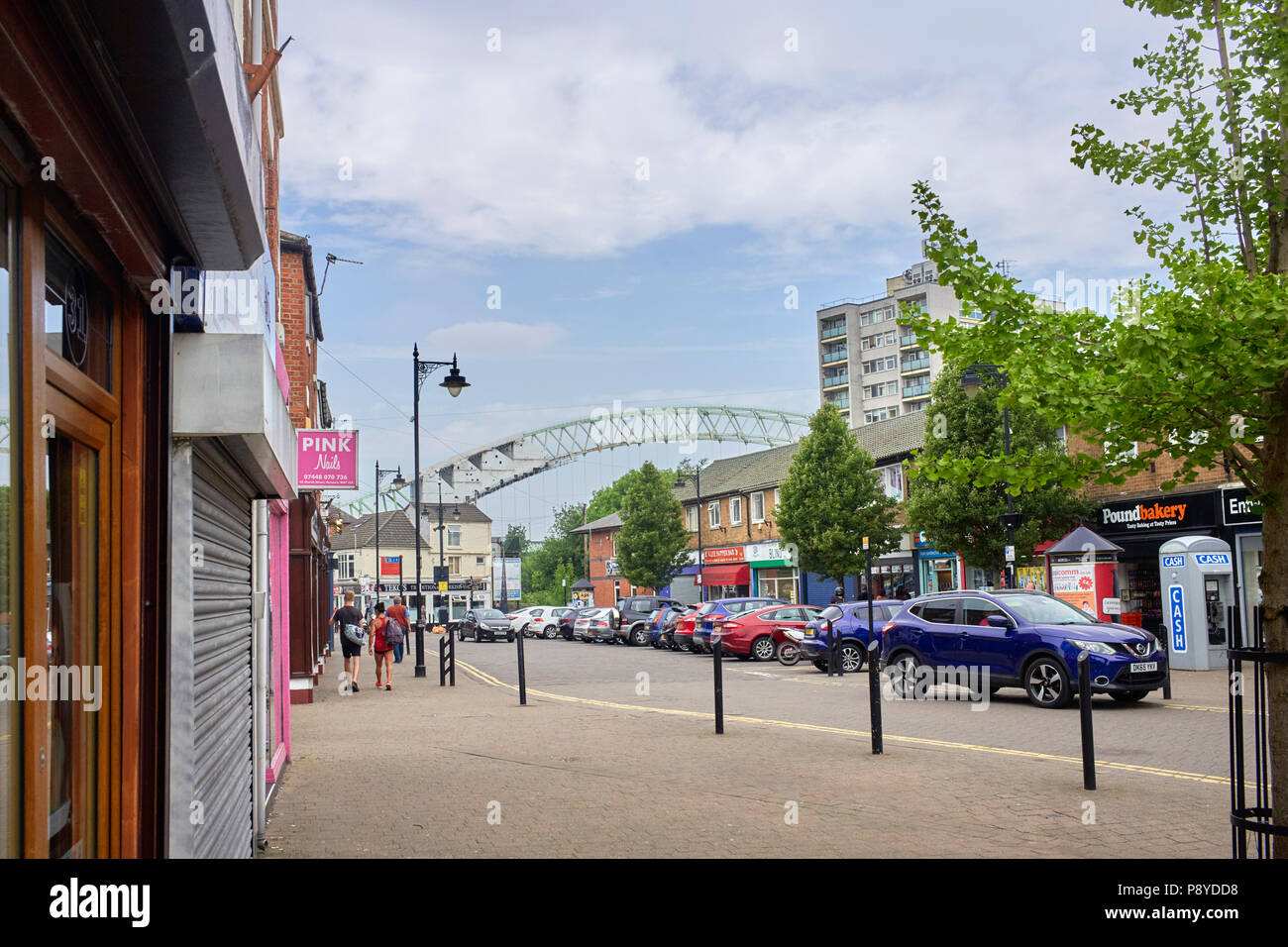 Shopping street in Runcorn Cheshire with the Silver Jubilee roadbridge in the background Stock Photo