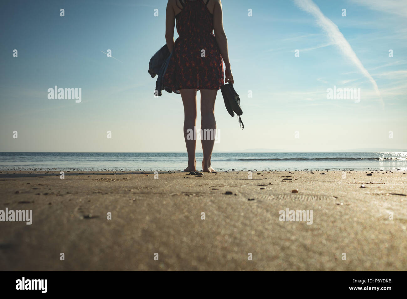 Woman standing sea shore sky beach hi-res stock photography and images ...
