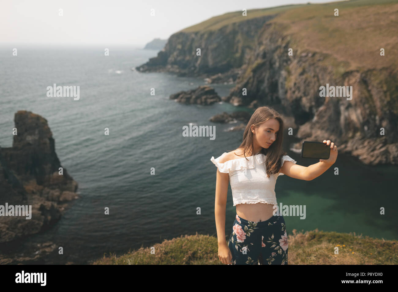 Woman taking selfie edge of the cliff Stock Photo Alamy