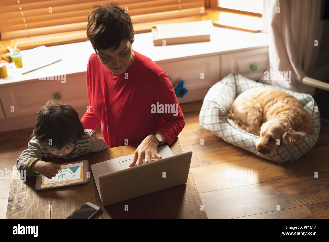 Mother and son using laptop and digital tablet Stock Photo