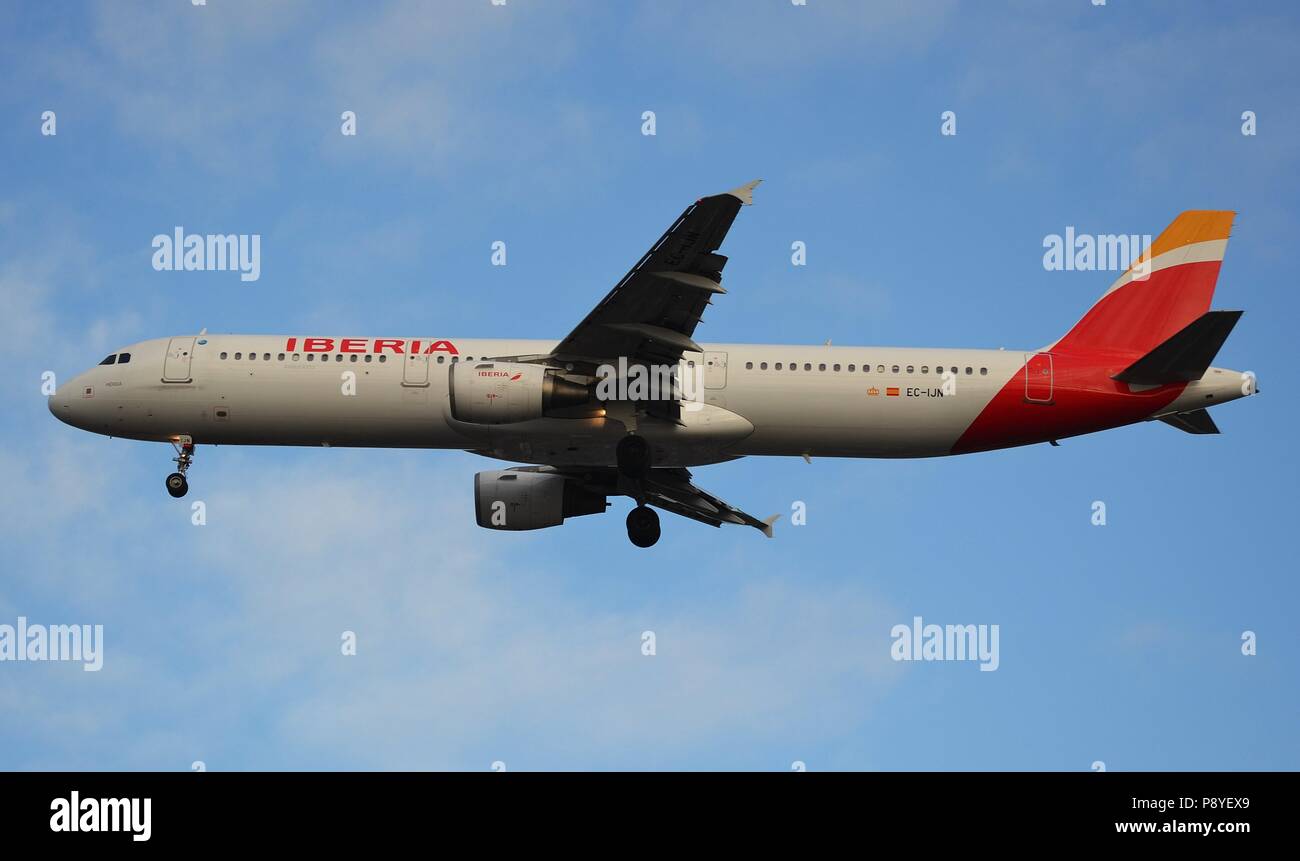 An Iberia Airbus A321 approaches runway 27R after a flgiht from Madrid, Spain Stock Photo