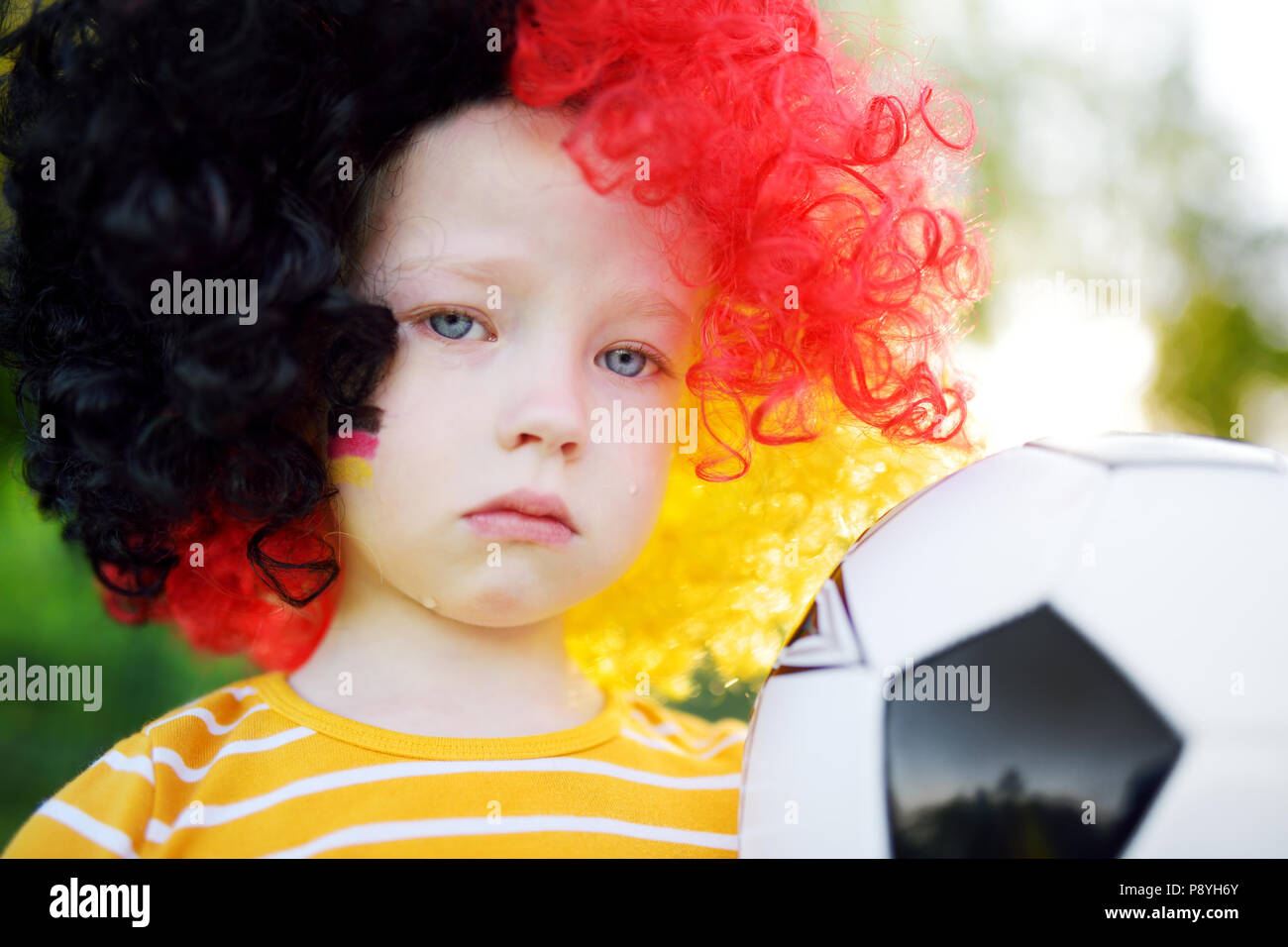 Sad little german child crying over her national football team's loss