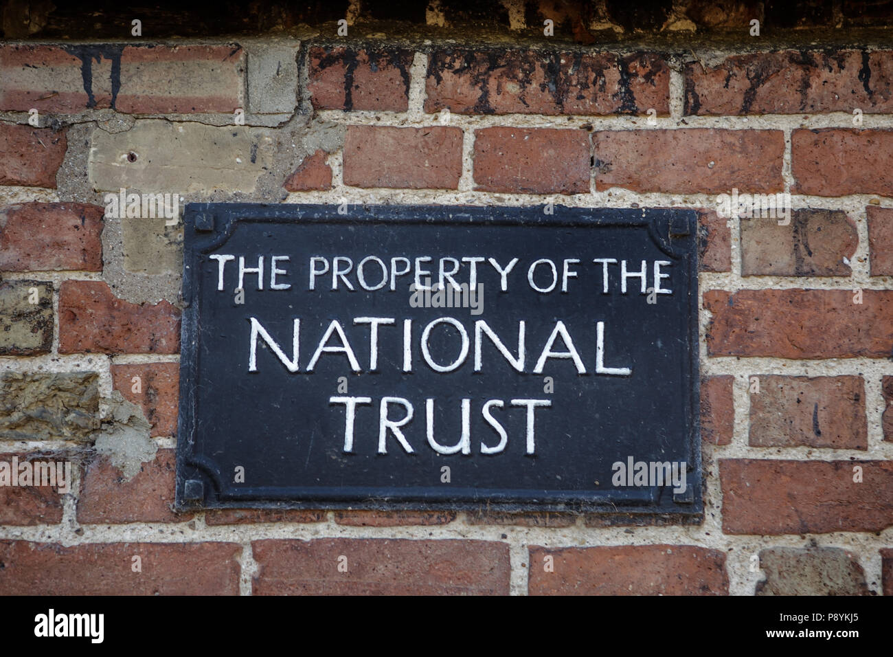close up image of nation trust sign on a brick wall Stock Photo