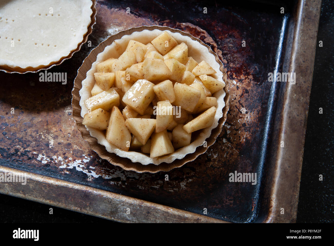 Mini Apple Pie on Baking Sheet, High Angle View Stock Photo