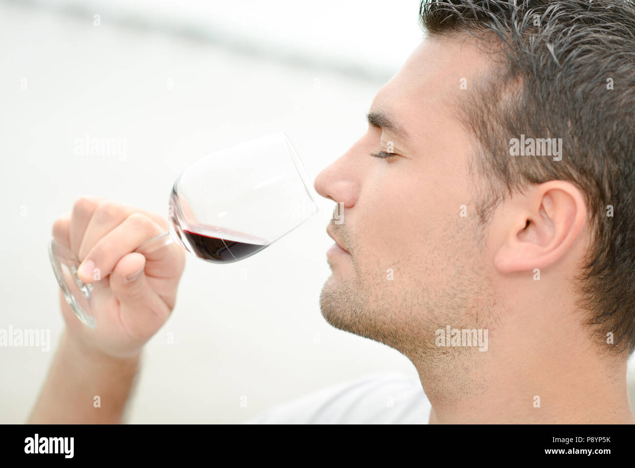 Man smelling red wine Stock Photo - Alamy
