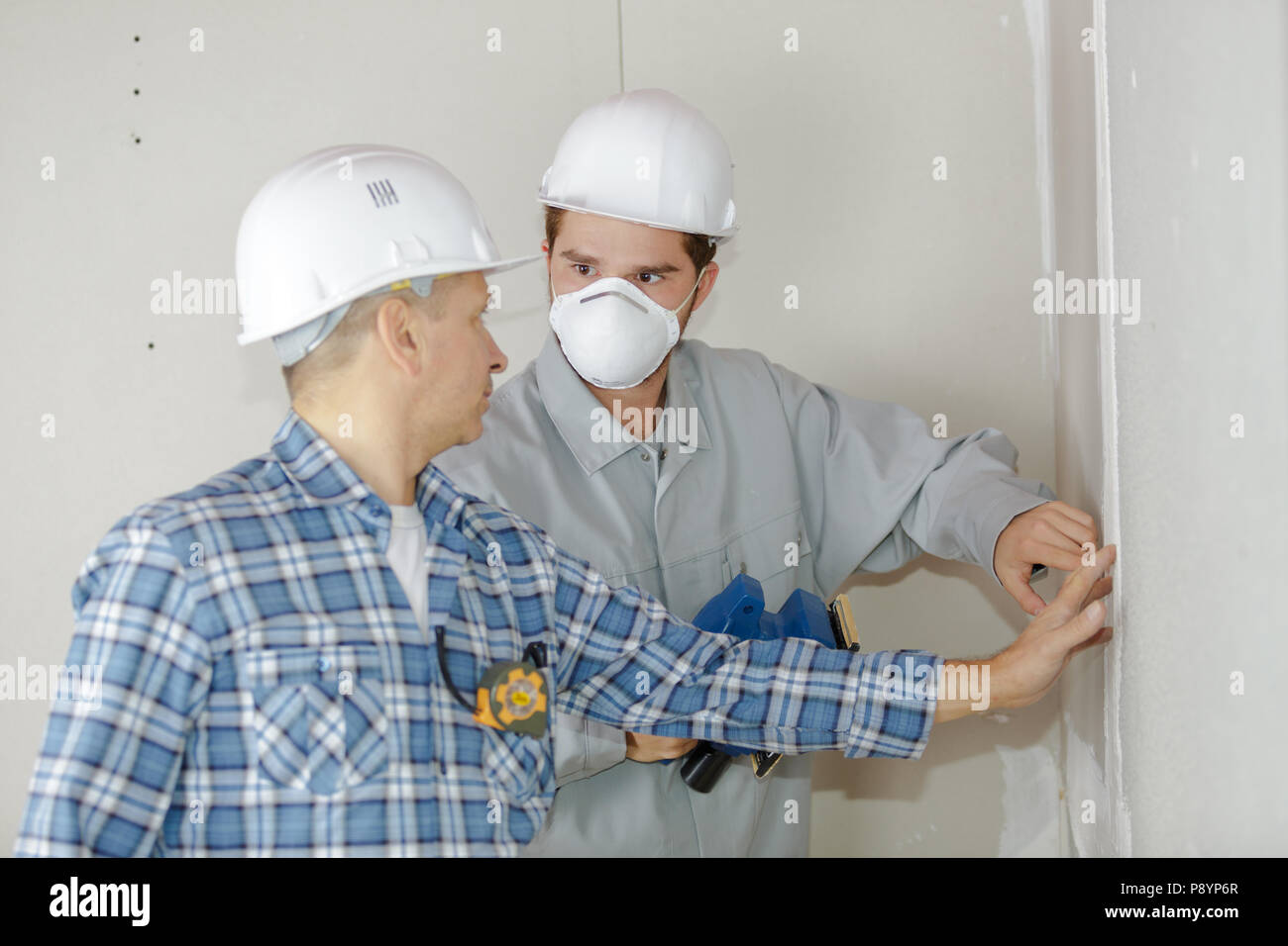 2 technicians working together at a construction site Stock Photo