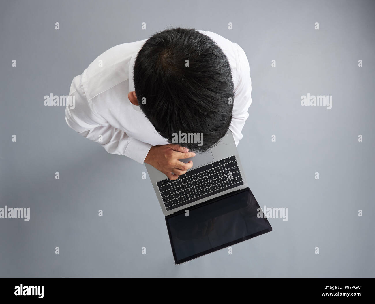 Man using laptop isolated on gray background above top view Stock Photo