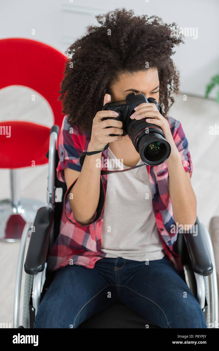 young woman on the wheelchair taking a photograph Stock Photo - Alamy