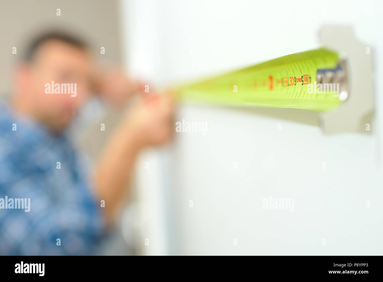 Measuring the length of a wall Stock Photo Alamy