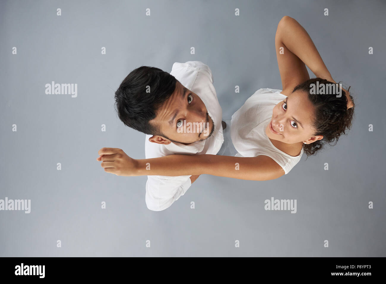 Young couple above  top view stand isolated on gray background Stock Photo