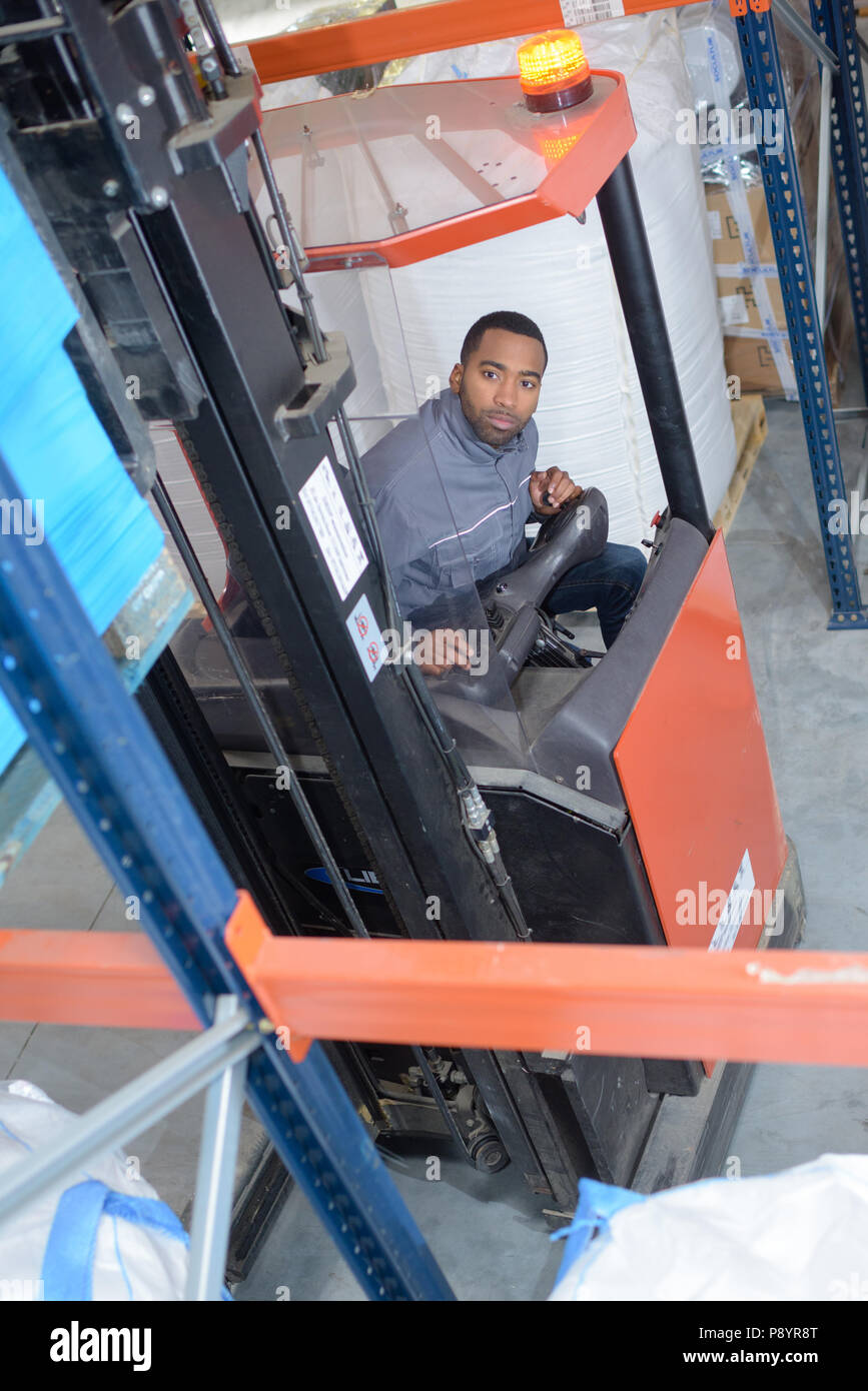Downward view of man driving forklift Stock Photo