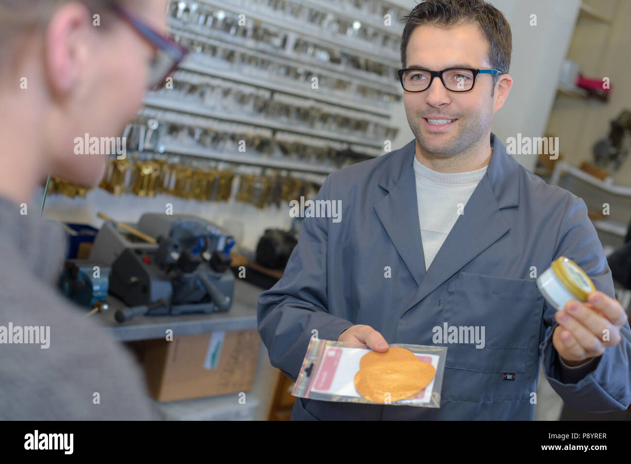 Cobbler suggesting products to customer Stock Photo Alamy