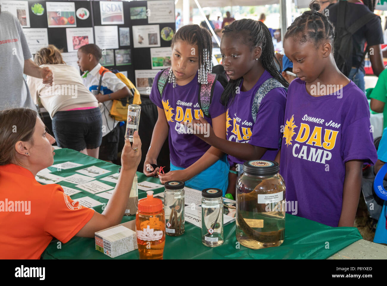 Detroit, Michigan - A worker for the Michigan Department of Natural Resources talks with youth about the sea lamprey (Petromyzon marinus) at Metro Det Stock Photo