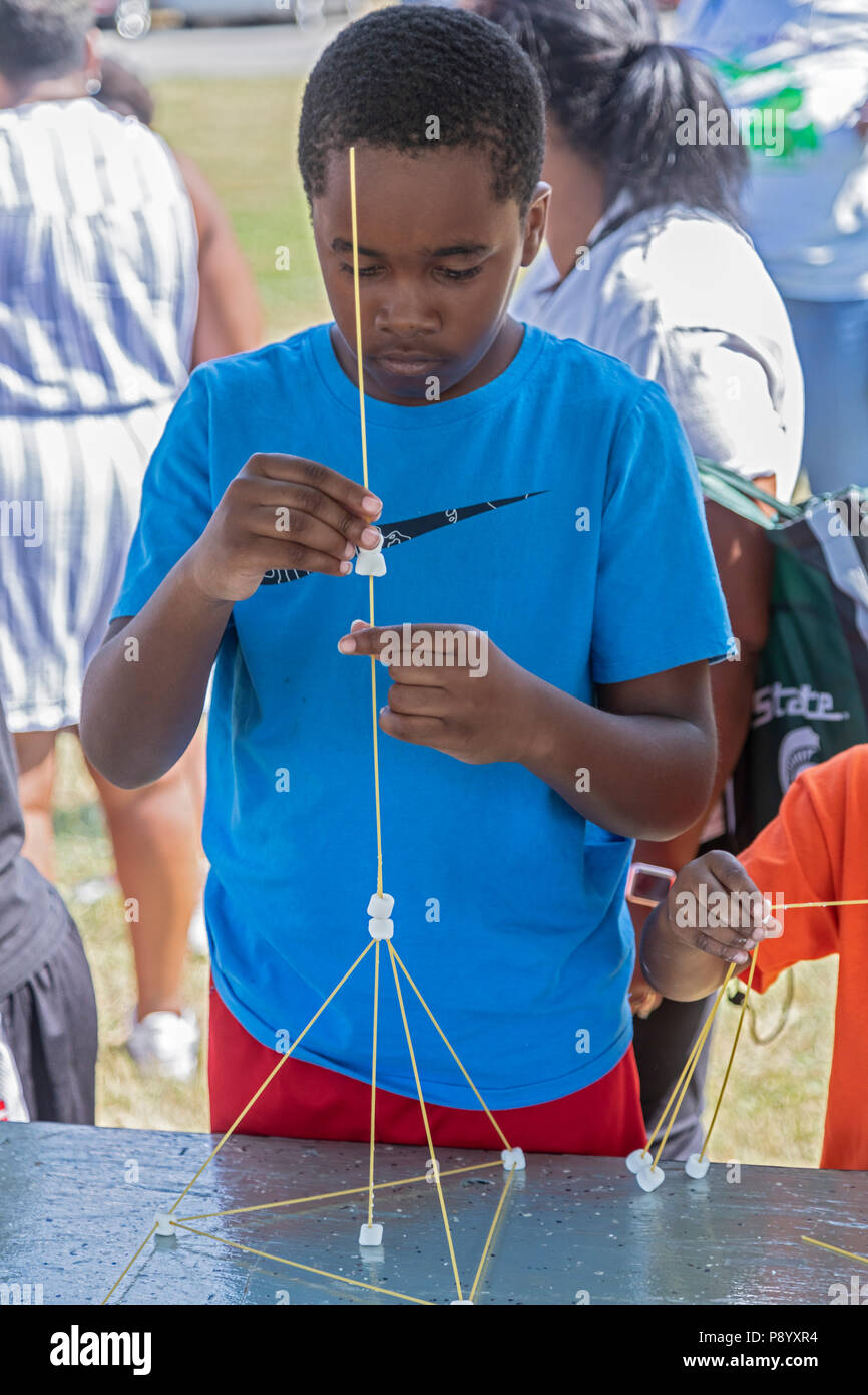 Detroit, Michigan - Children build structures with spaghetti and marshmallows at Michigan State University's booth during Metro Detroit Youth Day. Tho Stock Photo