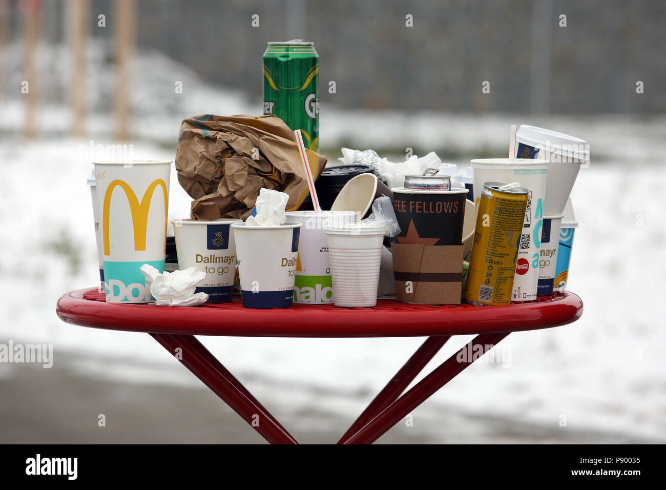 Hermsdorf, Germany, Empty coffee mugs, beverage cans and crumpled paper ducks on a rest area table Stock Photo