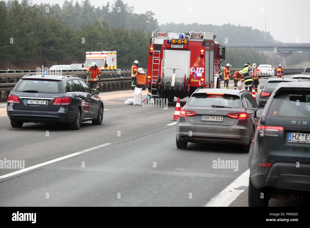 Allersberg, Germany, Firefighters eliminate after a car accident on the A9 a oil trail Stock Photo