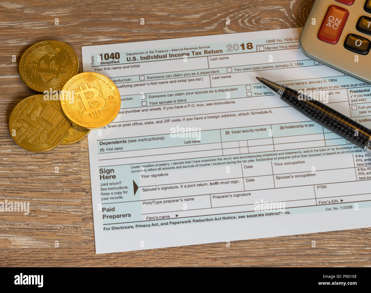 Form 1040 Simplified with bitcoin coins for reporting currency gains Stock Photo