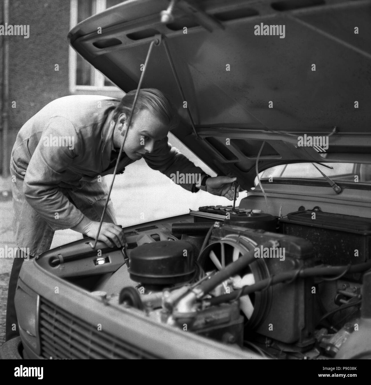 Berlin, GDR, car mechanic repairs the engine of a Wartburg Stock Photo