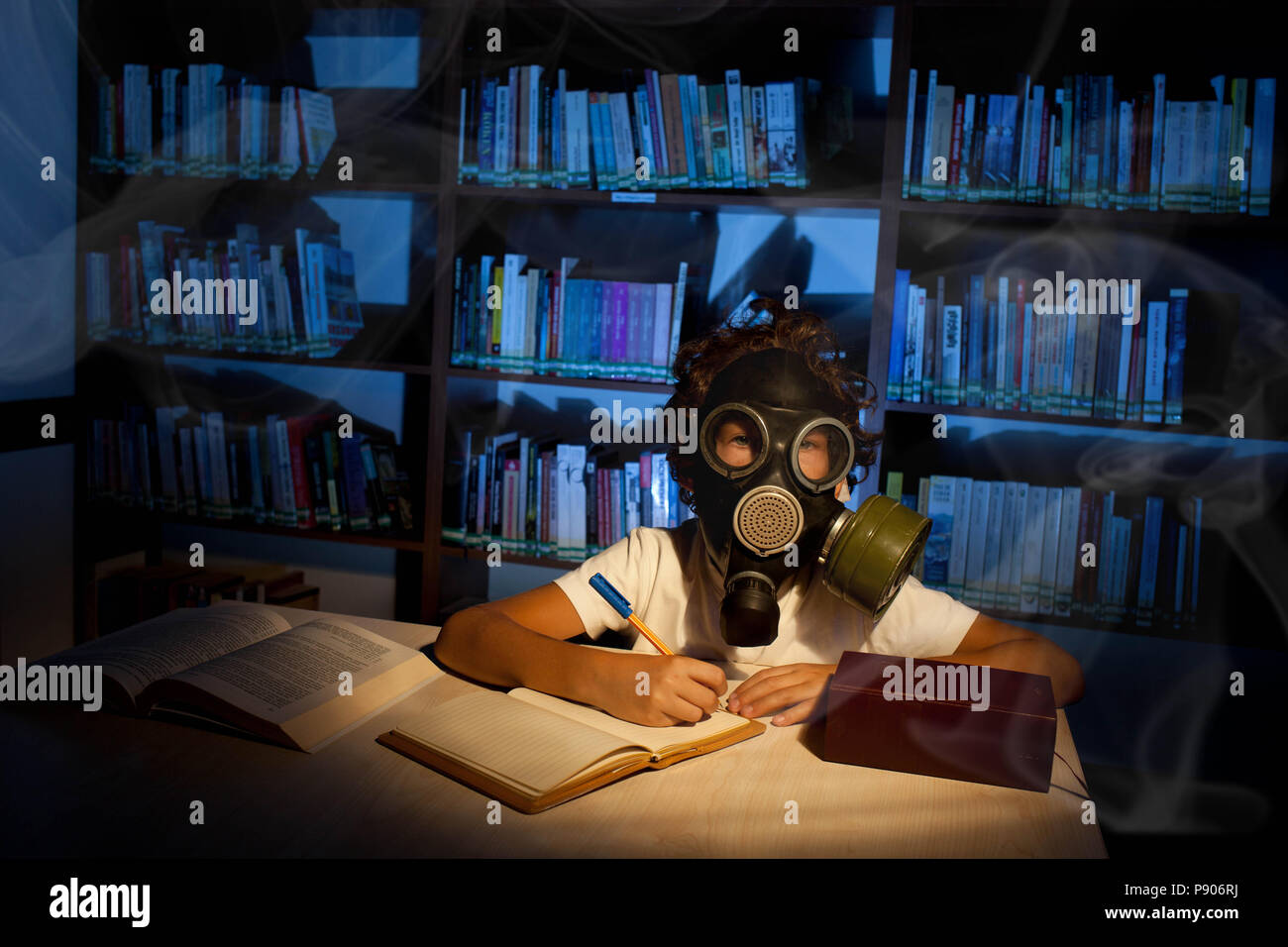 Child studying in the library, thinking, day dreaming Stock Photo
