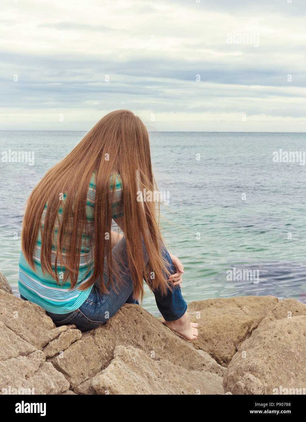 Sad girl sitting. Lonely woman is sad Stock Photo - Alamy