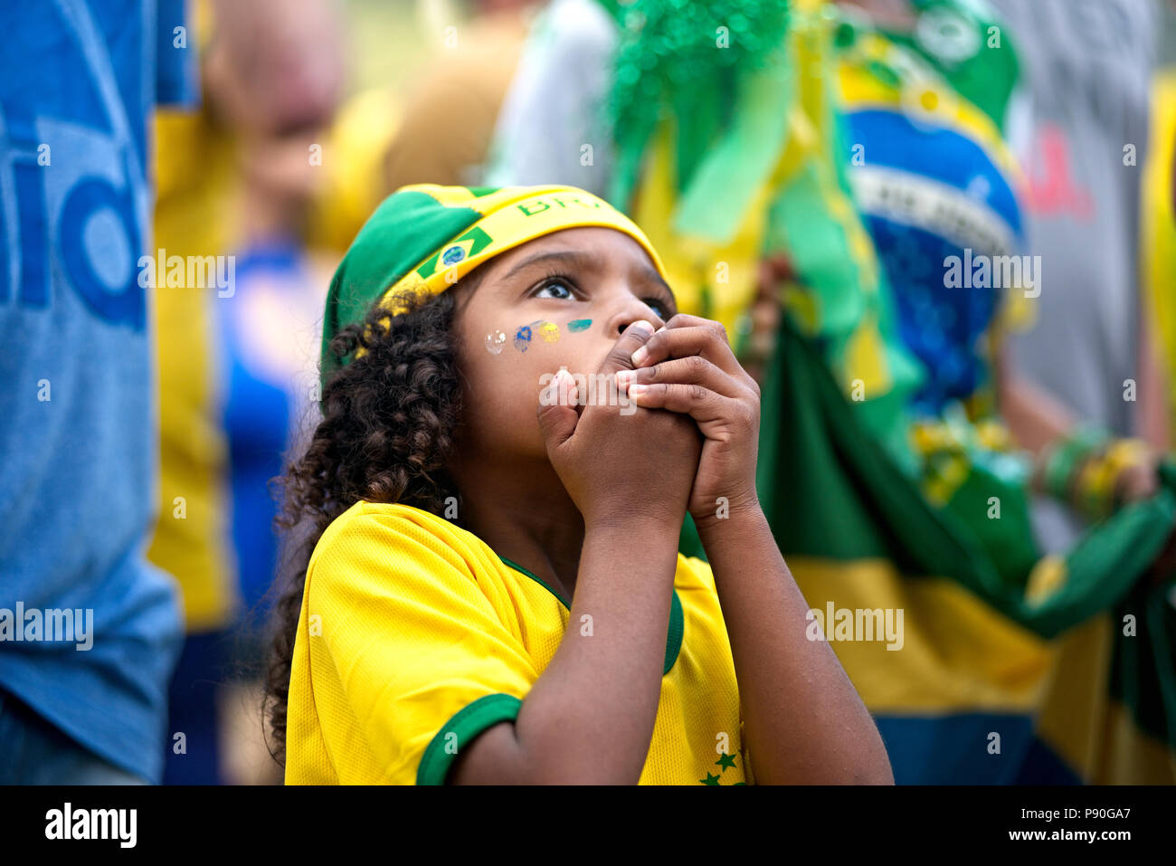 Brazil - June 27, 2018: Worried young Brazilian fan watches a live telecast of the match between Brazil and Serbia in downtown Rio de Janeiro Stock Photo