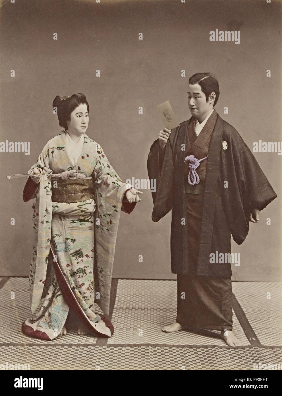 .   379 Kusakabe Kimbei - No title (Couple with a cabinet photograph and ghost in background) - Stock Photo