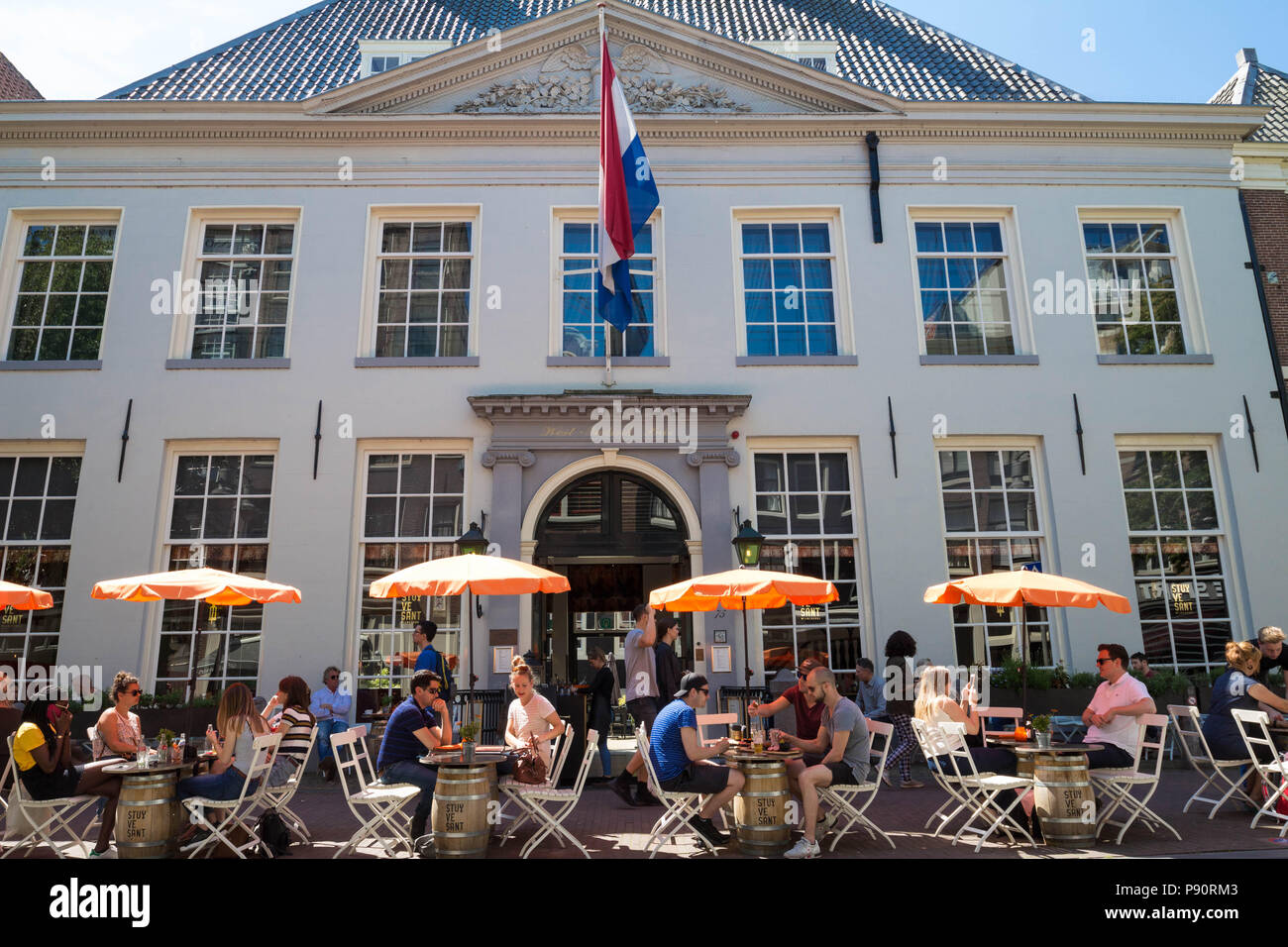 Tourists and local people enjoy the dutch cafe located near West India  house in centre of Amsterdam, Netherlands Stock Photo - Alamy