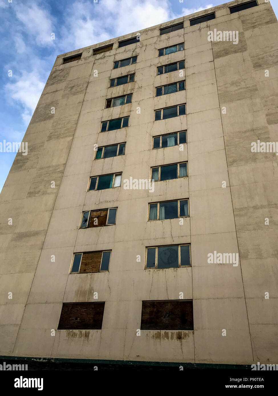 Derelict old concrete apartment building. Stock Photo